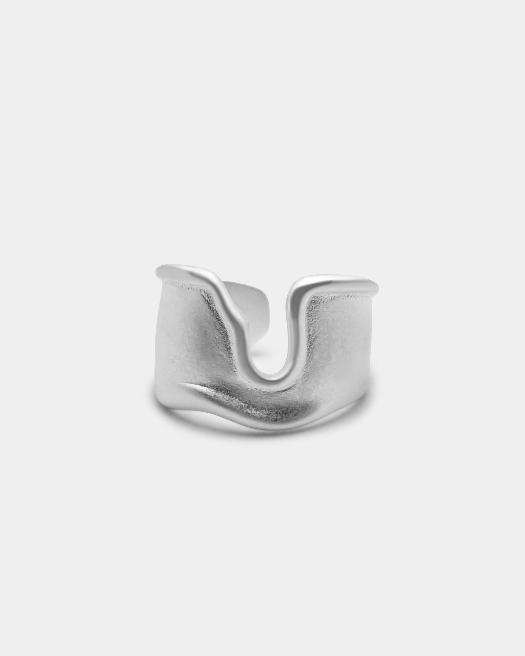 Ruin Ring in sterling silver with a raw, sculptural design and matte finish, shown against a light grey background – Ahrensandco.